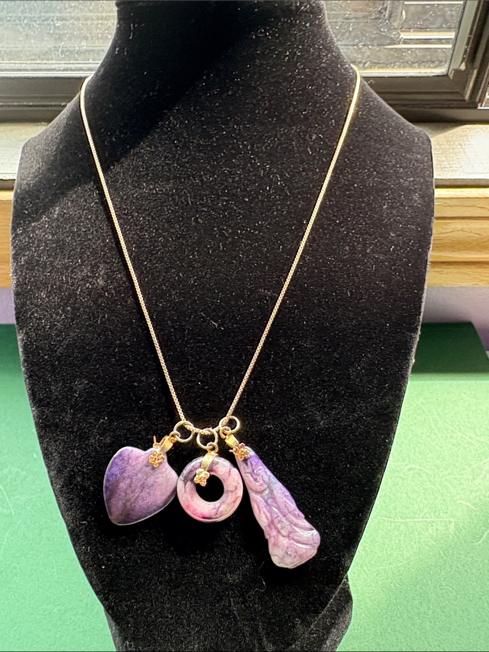 Gold tone necklace with 3 charms 20”
